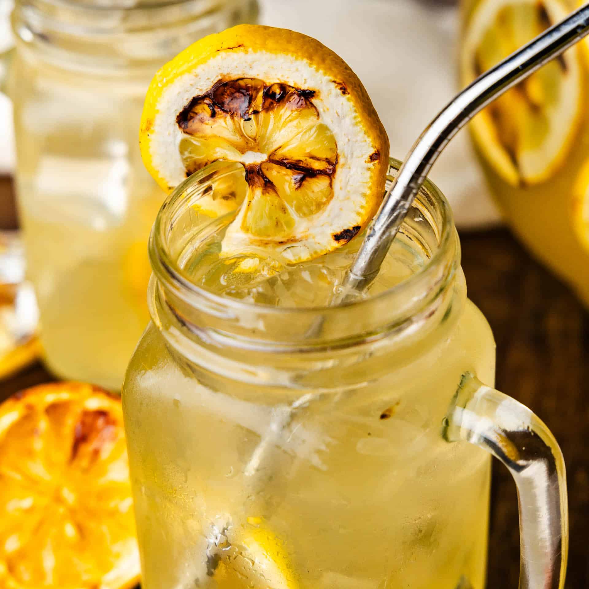 A close up view of a mason jar glass of grilled lemonade.