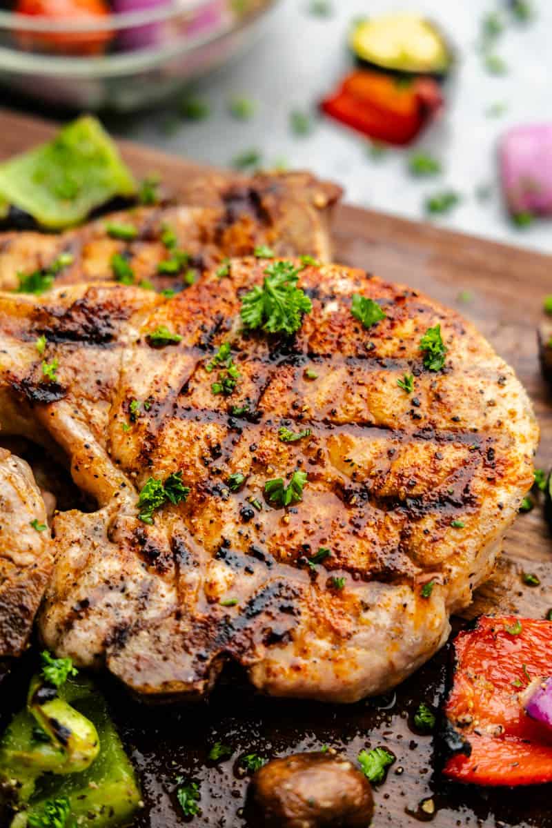 A grilled pork chop with  herbs and seasonings. 