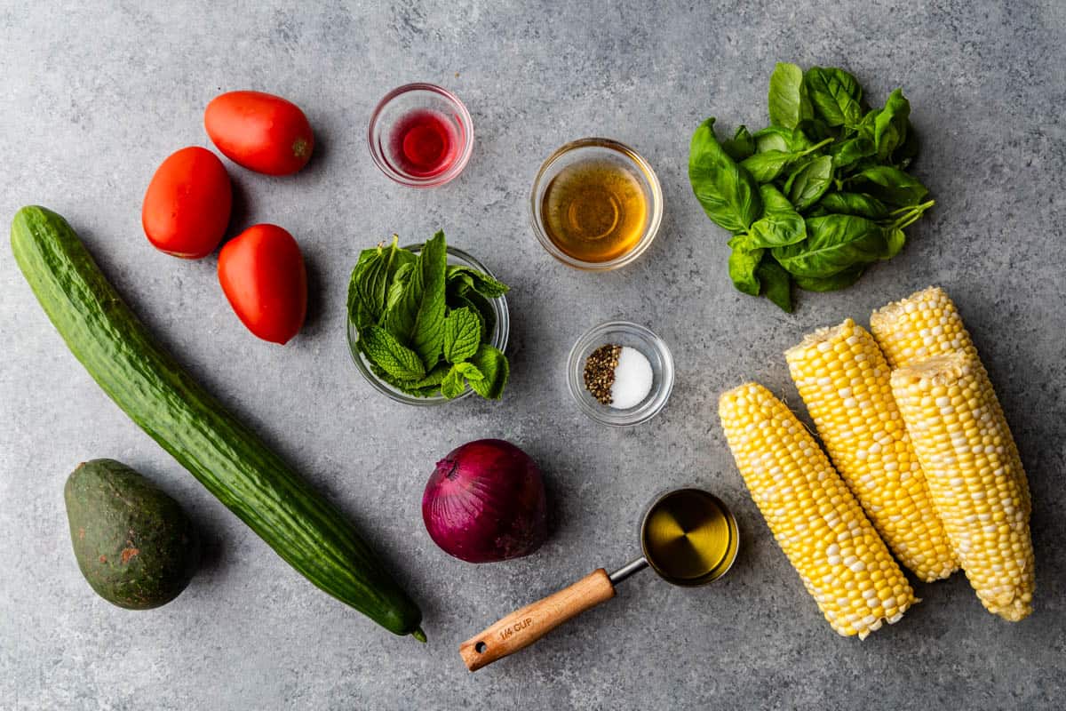 An overhead view of the ingredients needed to prepare summer corn salad. 