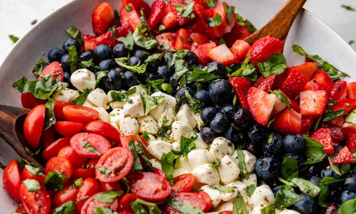 A bowl of red, white, and blue caprese salad.