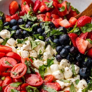 A bowl of red, white, and blue caprese salad.
