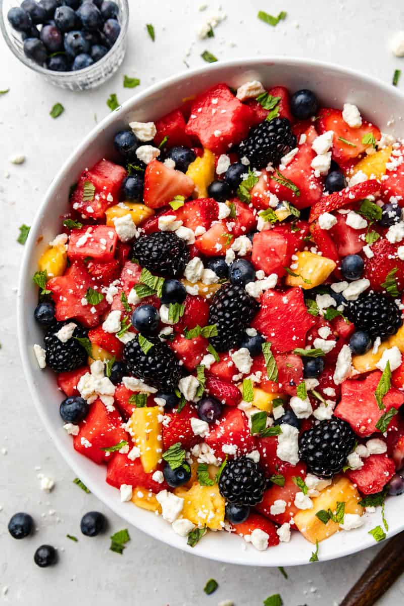A large bowl of red, white, and blue fruit salad on a table.