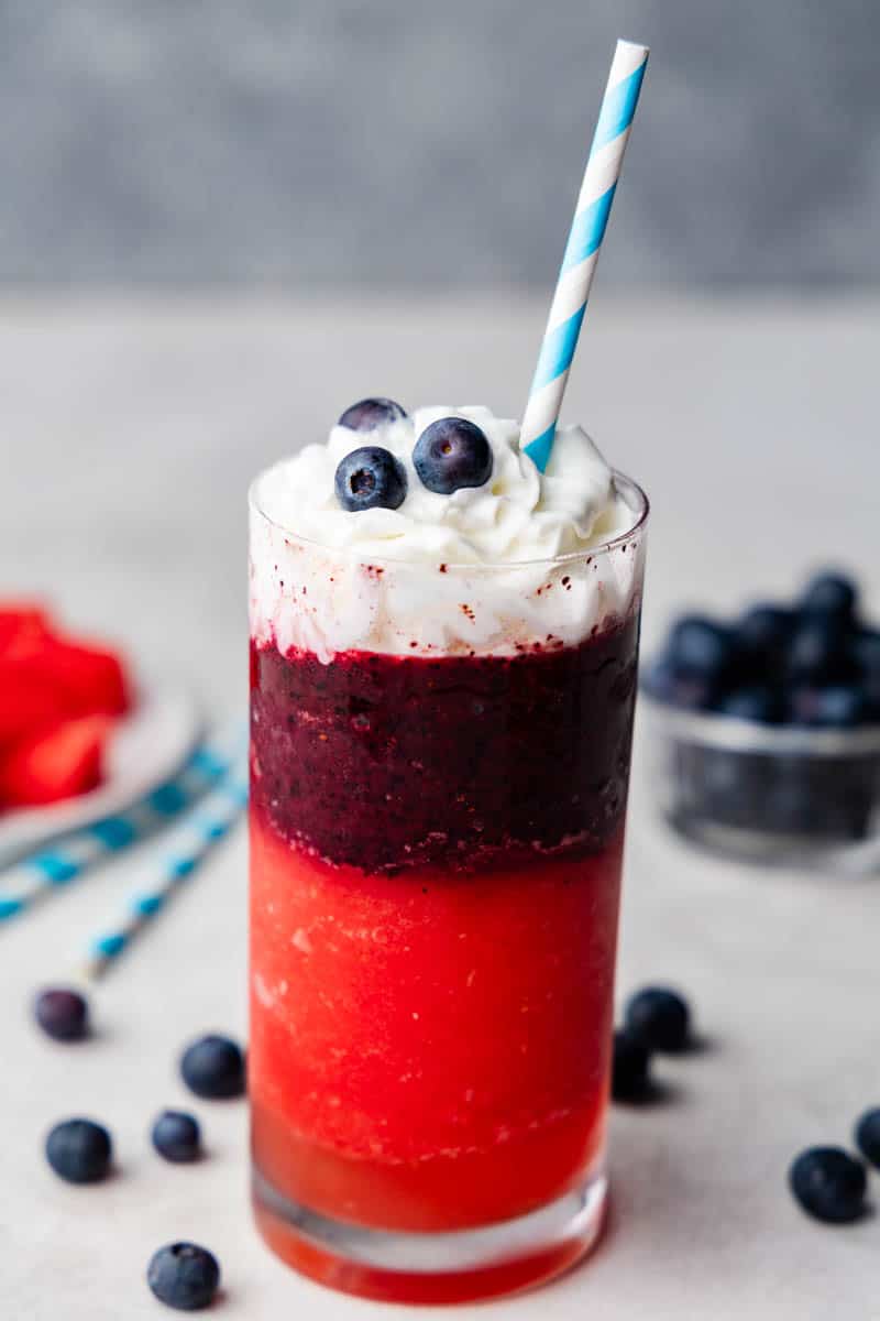A Red, White, and Blue Slushy with blueberries on top.