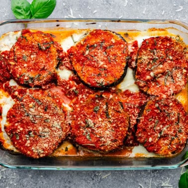 An overhead view of a pan of baked eggplant parmesan.