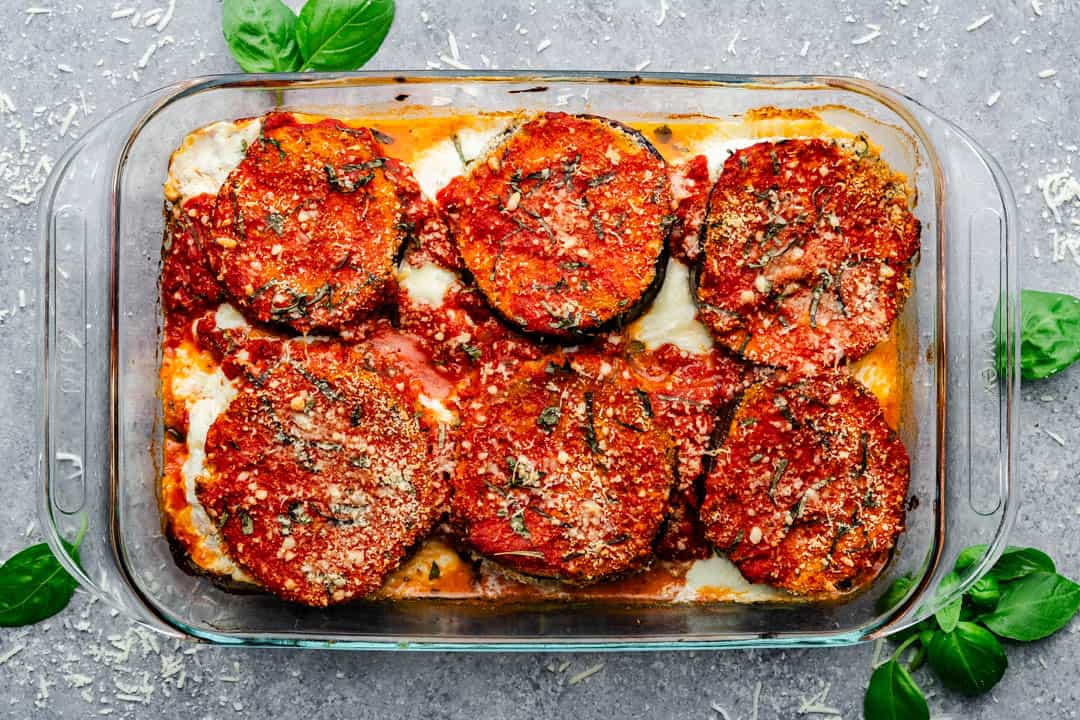 An overhead view of a pan of baked eggplant parmesan.