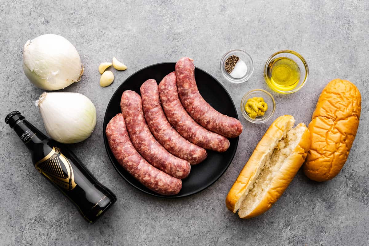 An overhead view of the ingredients needed to make beer braised bratwurst and onions.