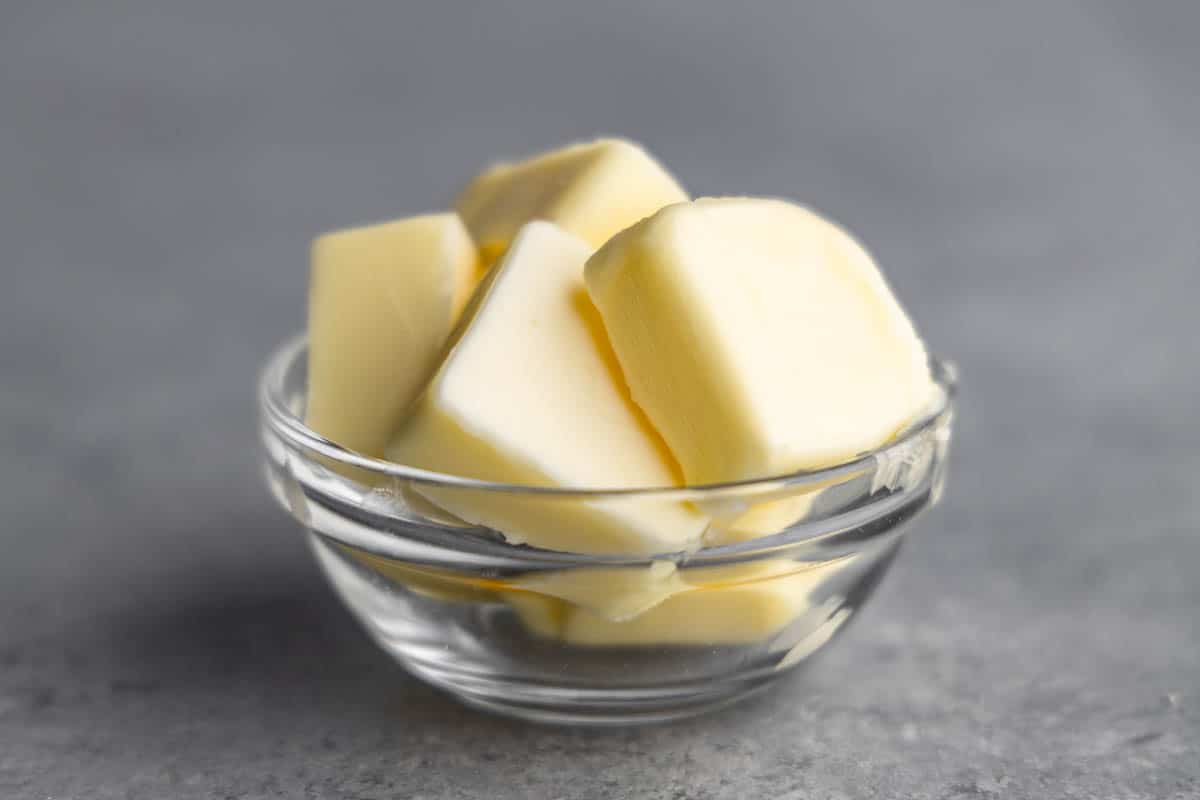 A clear bowl with cubes of butter.