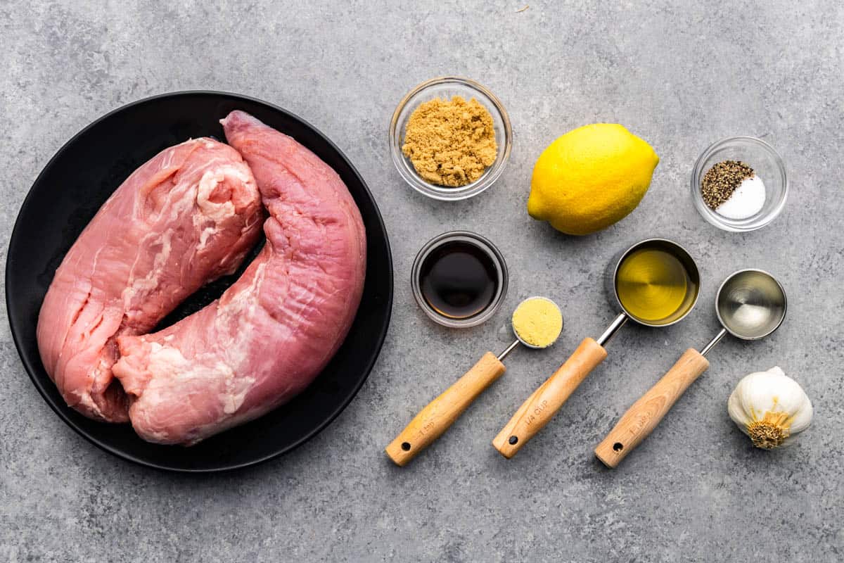 Ingredients for pork tenderloin are placed on a table.