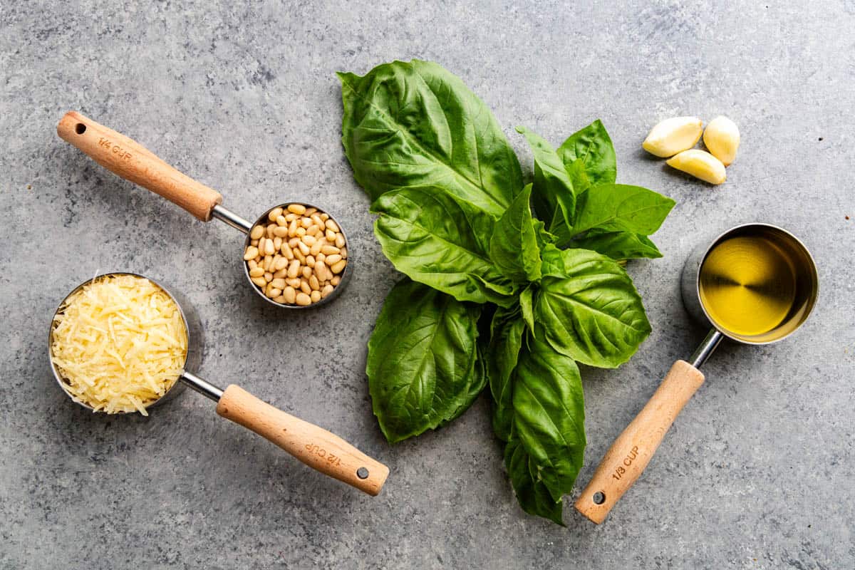 An overhead view of the ingredients needed to make pesto.