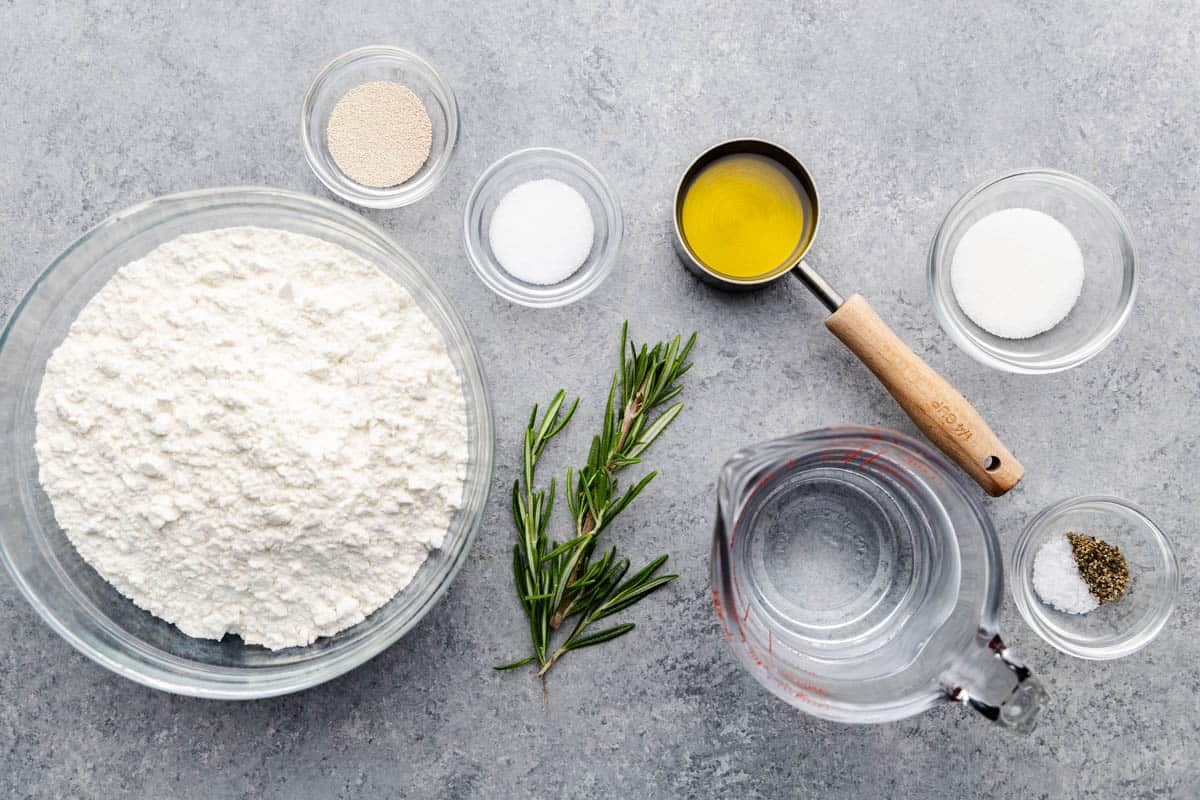 An overhead view of the ingredients needed to make homemade rosemary focaccia.