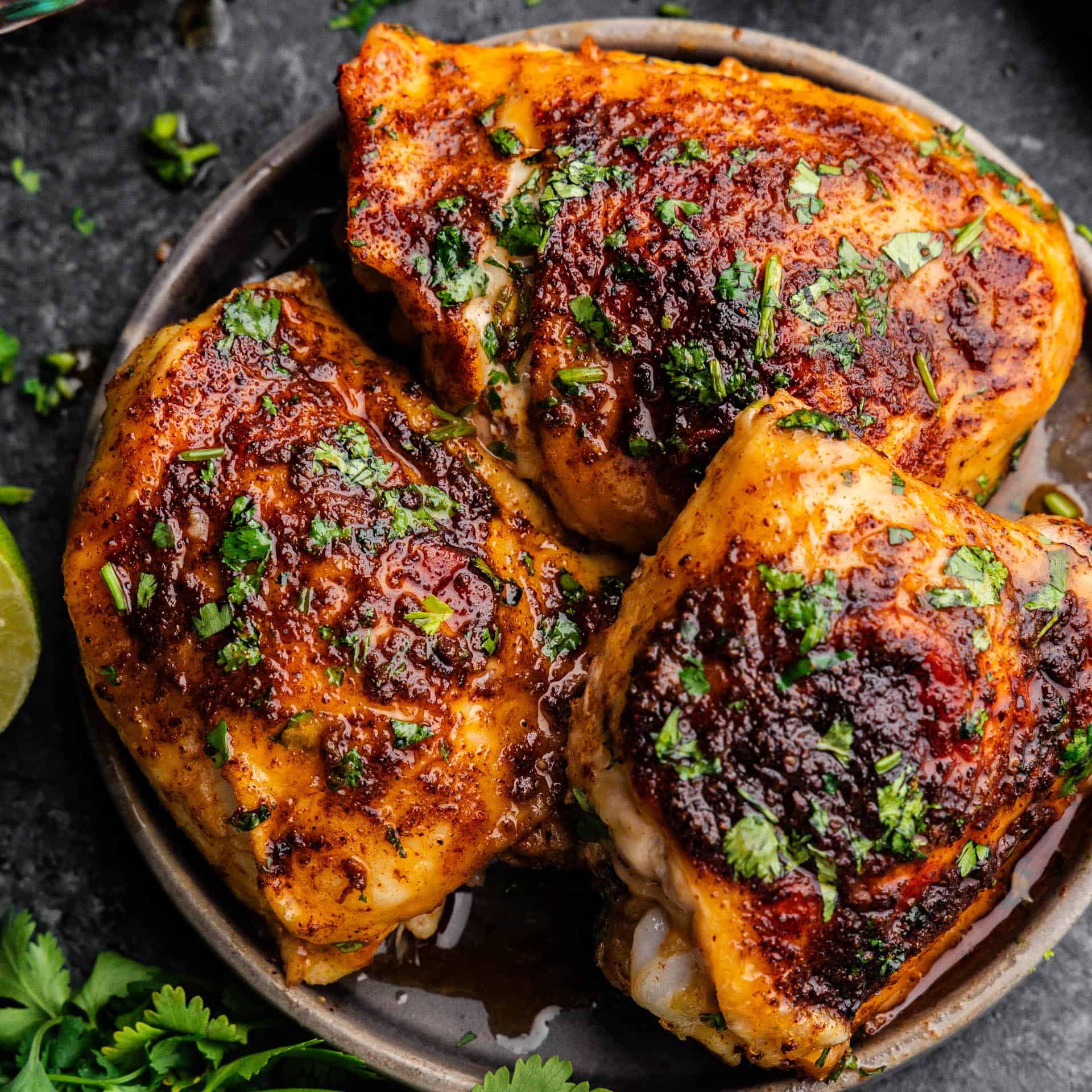 An overhead view of a plate of Mexican-spiced chicken thighs.