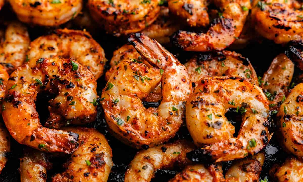 An overhead view of grilled shrimp on skewers.