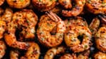 An overhead view of grilled shrimp on skewers.