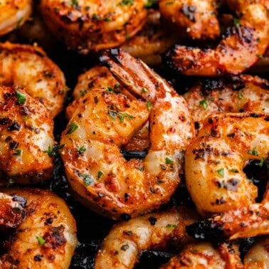 An overhead view of grilled shrimp on skewers.