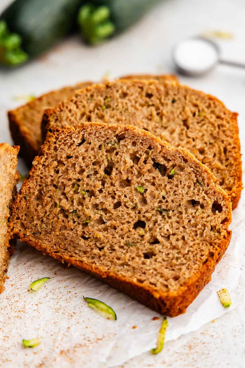 Three thick slices of zucchini bread laying in on each other like dominos.