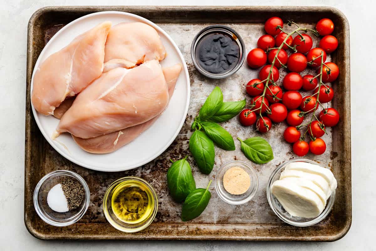 An overhead view of the ingredients needed to make sheet pan chicken caprese.