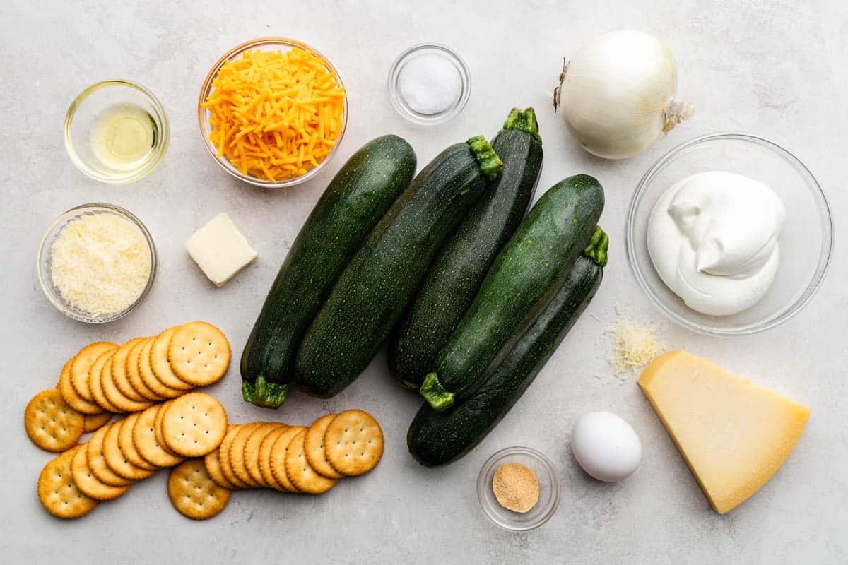 A diagram of raw, fresh and dried ingredients to use in zucchini casserole.