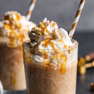 Two pumpkin spice frappes on a table.