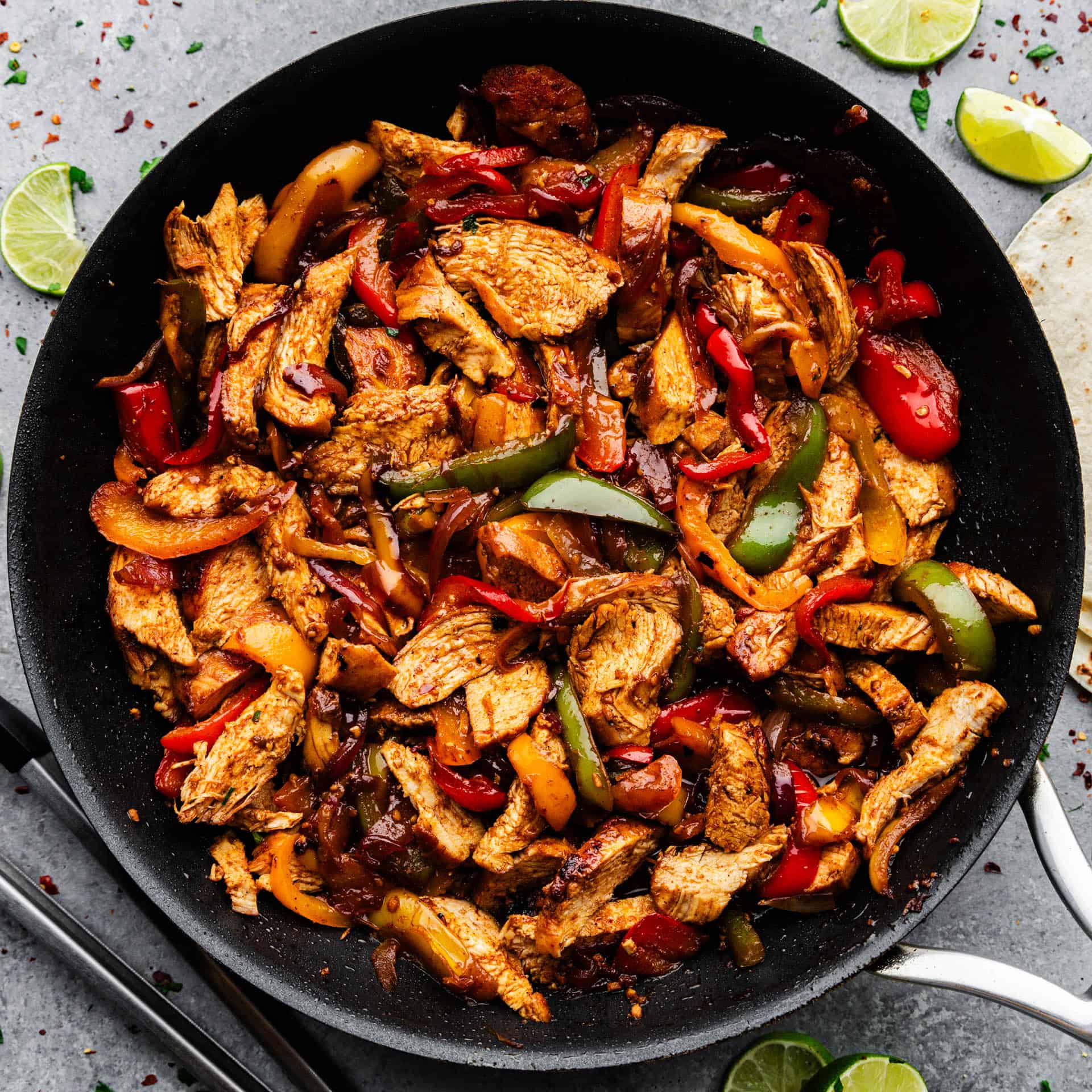 A view of a skillet full of chicken fajitas.