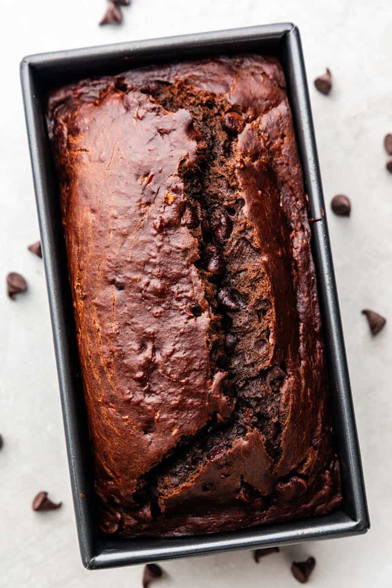 An overhead view of a loaf of chocolate banana bread still in the loaf pan.