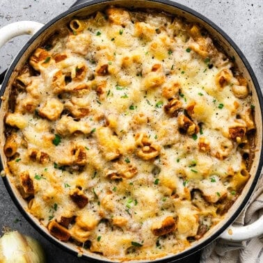 An overhead view of a pot of French onion pasta casserole.