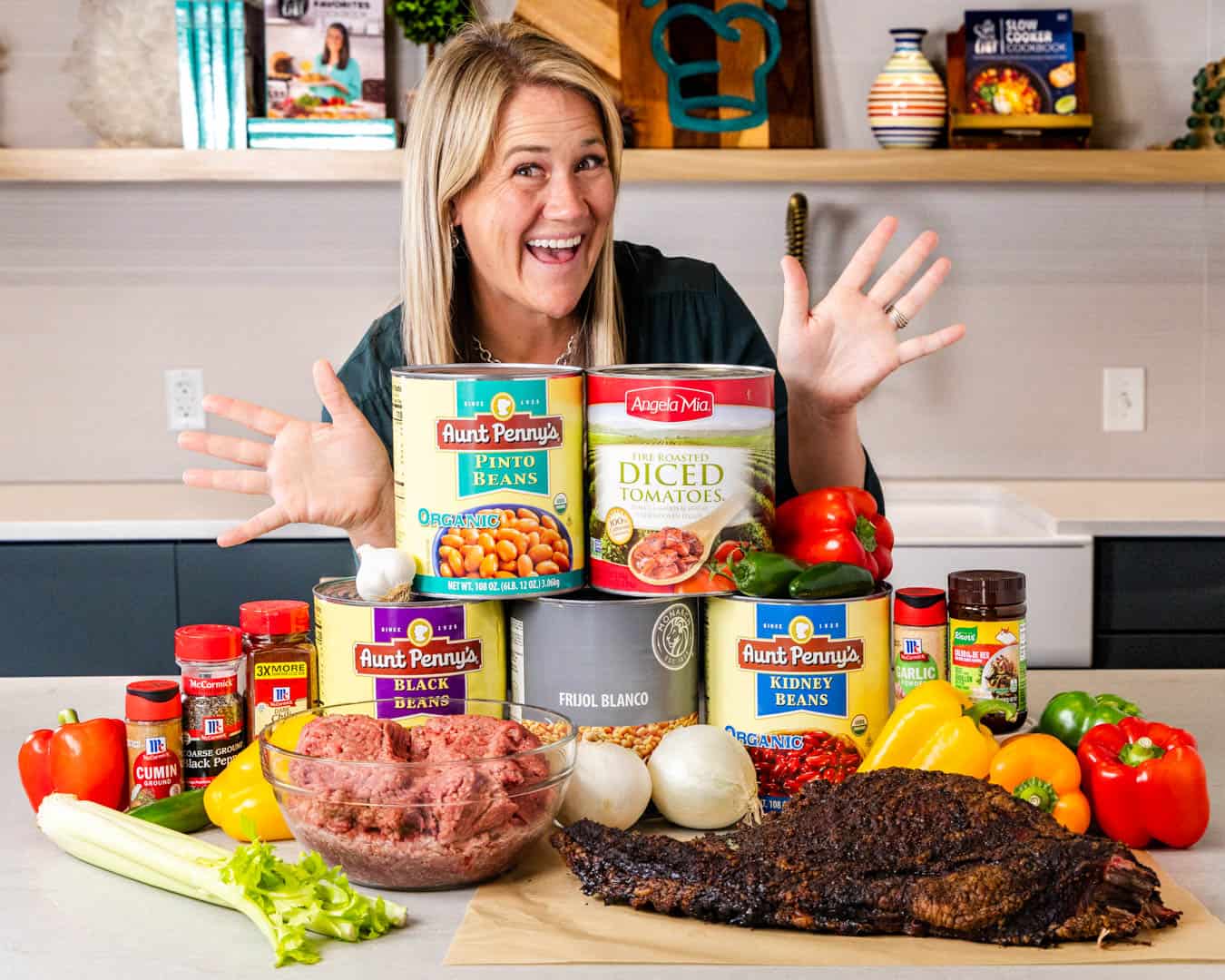 A photo of Caytlin McCleery with the ingredients needed to make her famous party chili.