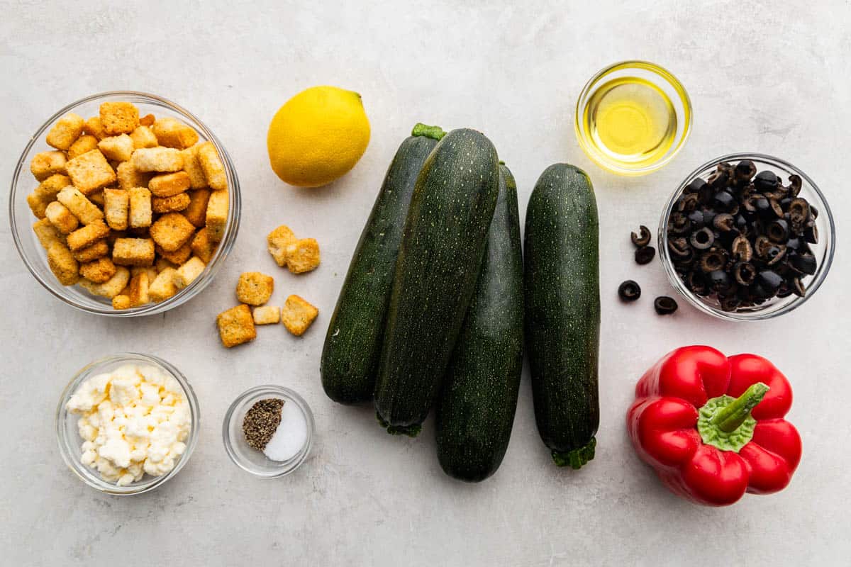 An overhead view of the ingredients needed to make Mediterranean Stuffed Zucchini.