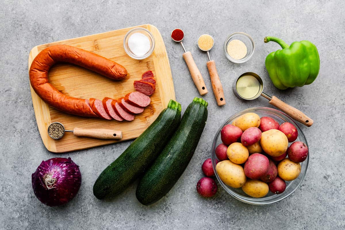 An overhead view of the ingredients needed to make the sheet pan sausages and vegetables.