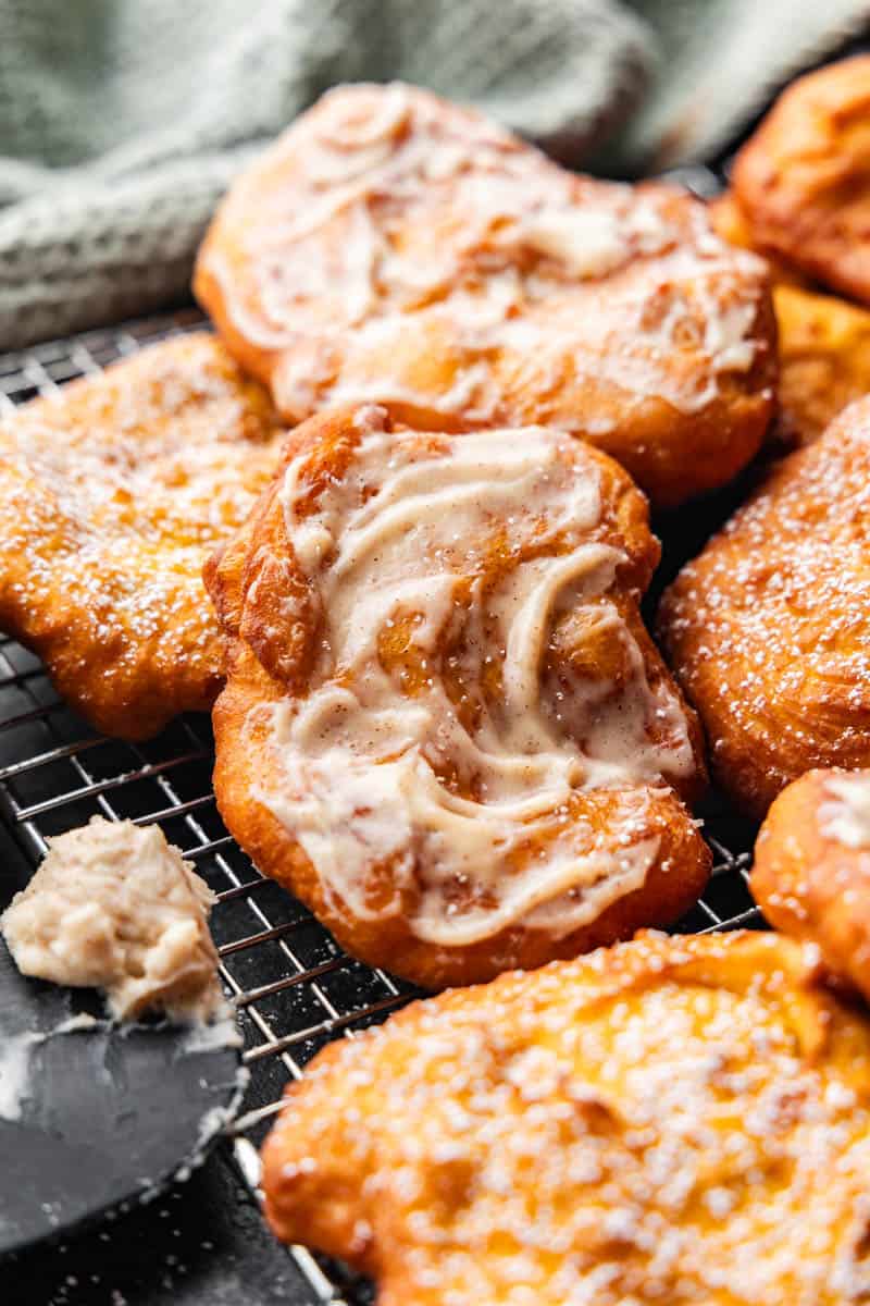 A pile of pumpkin fry bread lathered with cinnamon cream cheese butter.