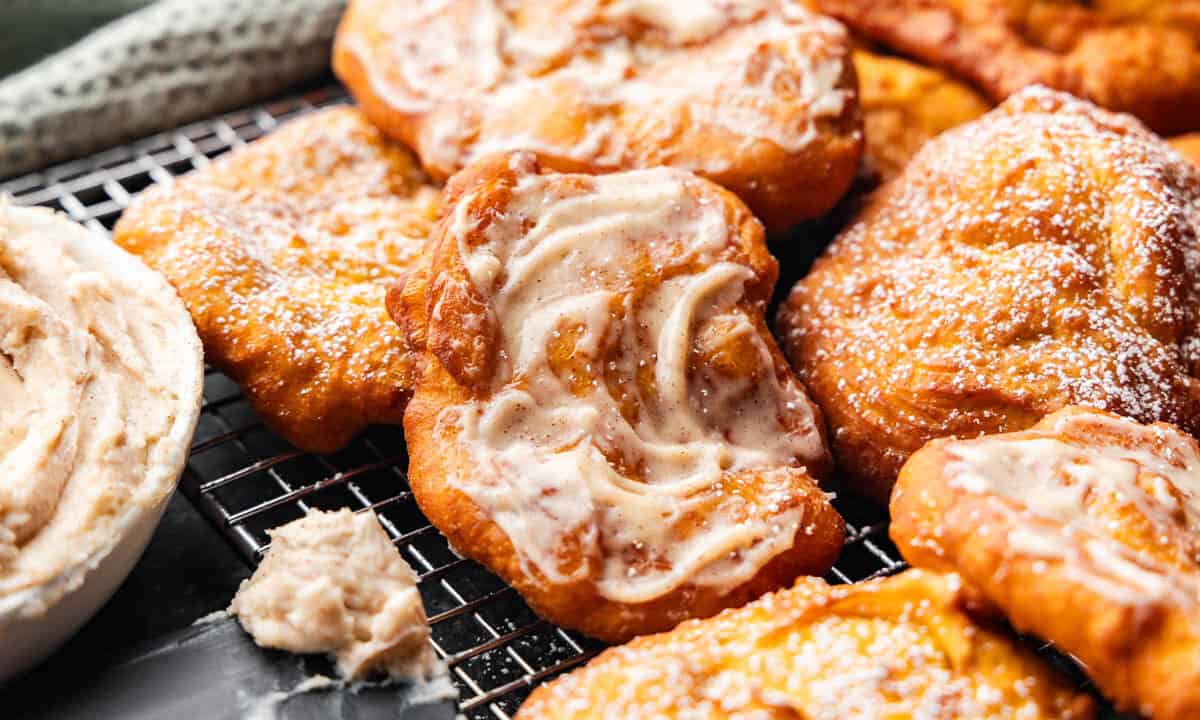 A pile of pumpkin scones with a cinnamon cream cheese butter.