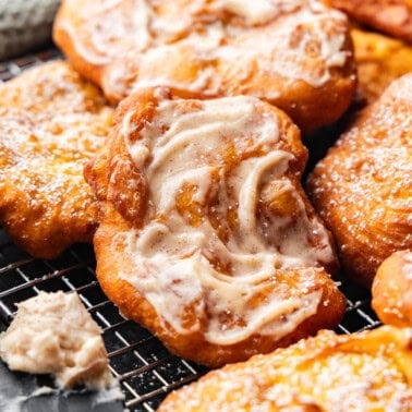 A pile of pumpkin scones with a cinnamon cream cheese butter.