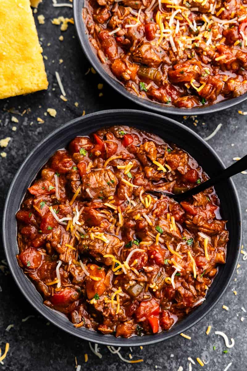 An overhead view of two bowls of Texas chili con carne prepared in the crockpot.