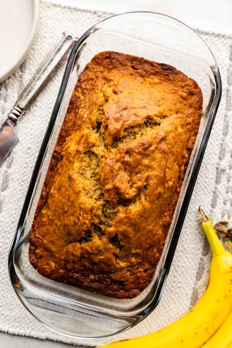 An overhead view of banana bread in a loaf pan.