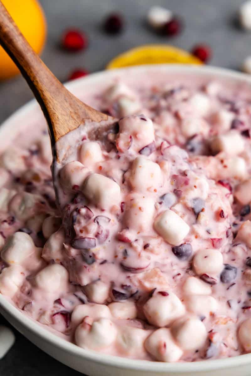 a large bowl of blueberry fluff with a spoon inside ready to serve