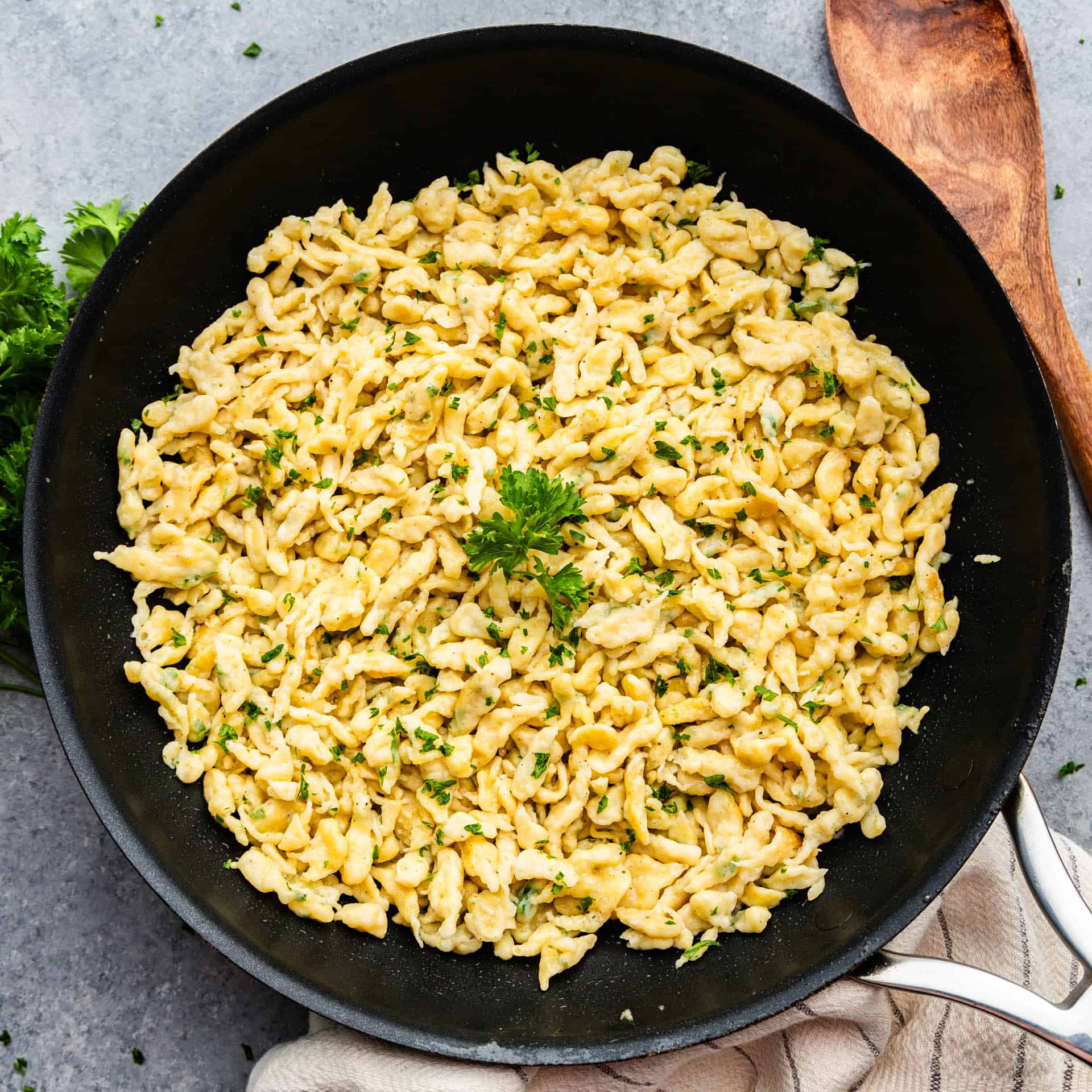 An overhead view of a skillet filled with Granny's German Spaetzle ready to serve.