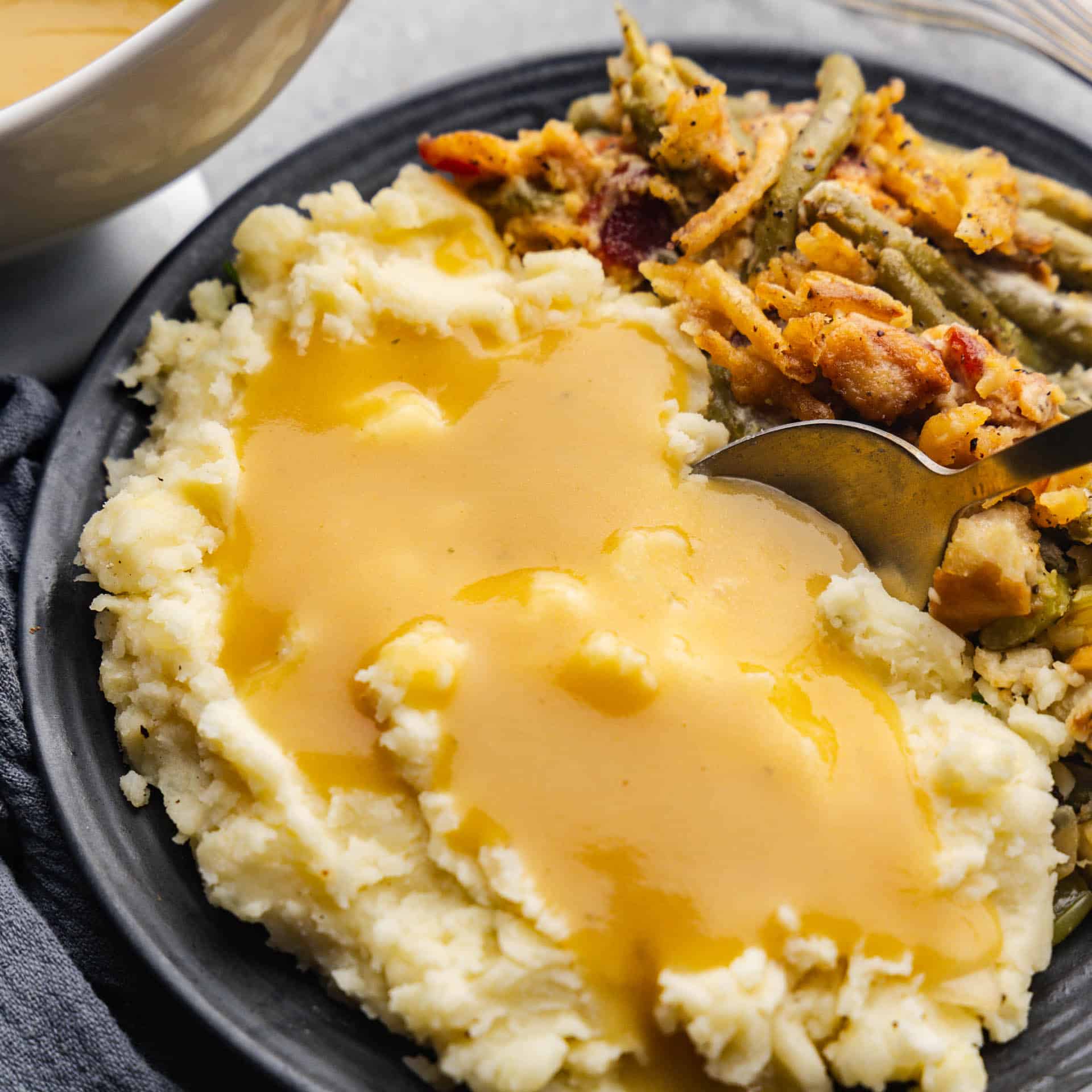 A plate of mashed potatoes and gravy.