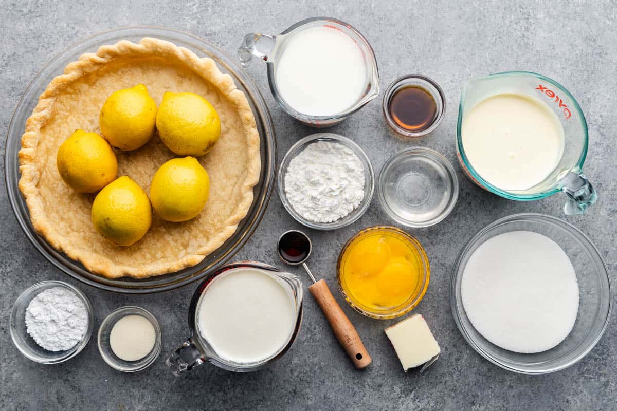 An overhead view of all the fresh, wet and dry ingredients needed to make an old-fashioned creamy lemon pie.