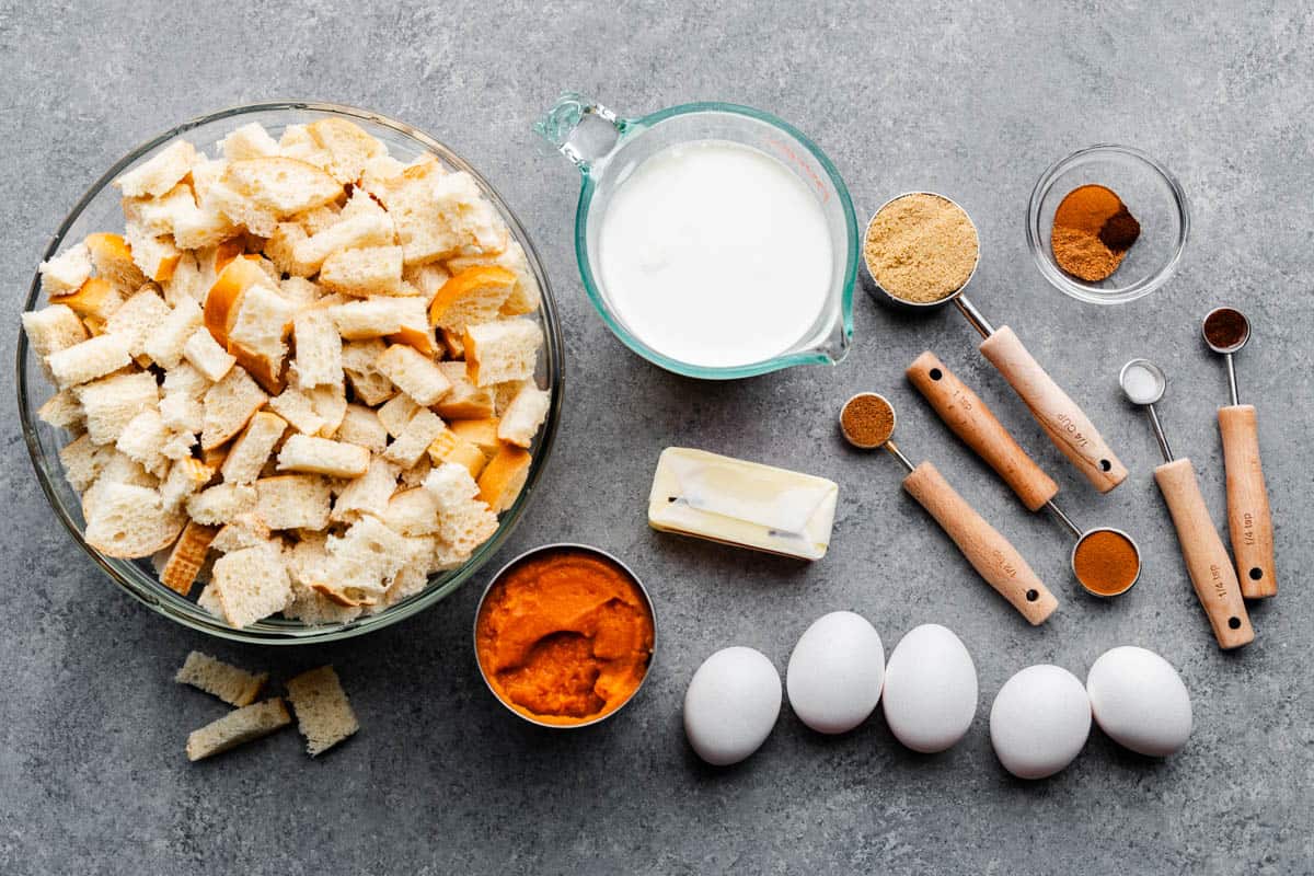 An overhead view of the ingredients needed to make slow cooker pumpkin french toast casserole