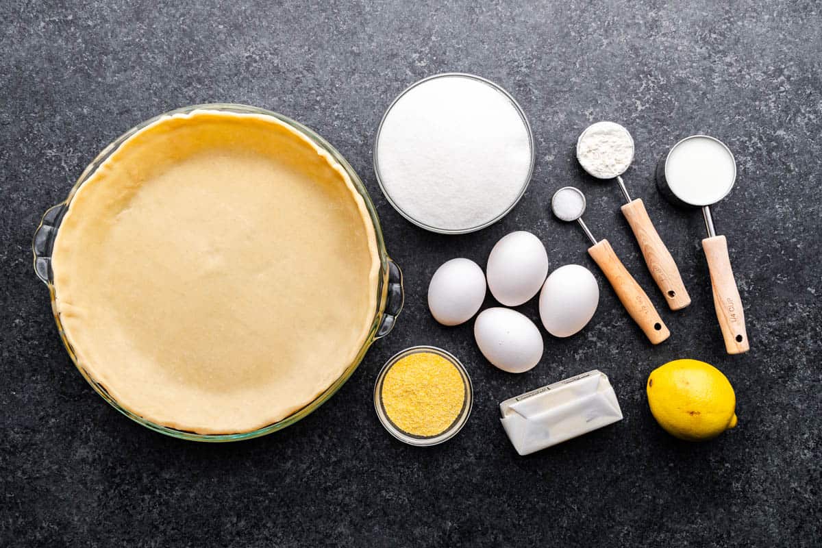 An overhead view of the ingredients needed to make a chess pie.