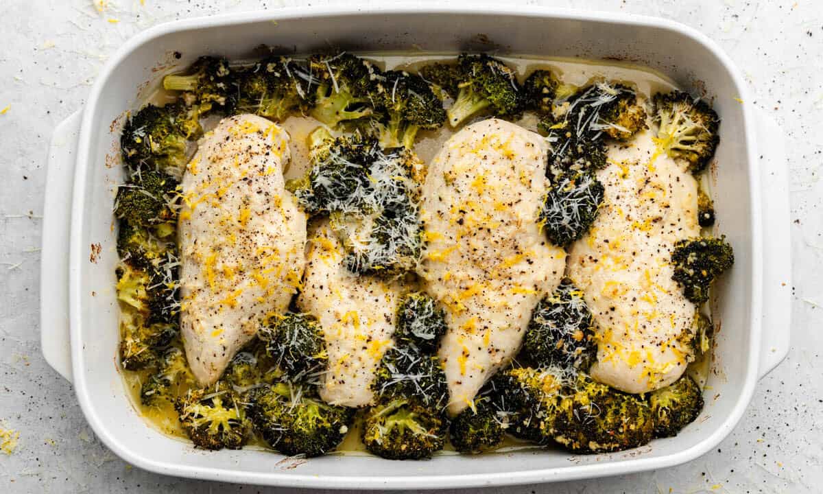 A 9x13 pan filled with lemon garlic chicken and broccoli.