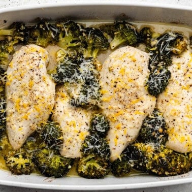 A 9x13 pan filled with lemon garlic chicken and broccoli.