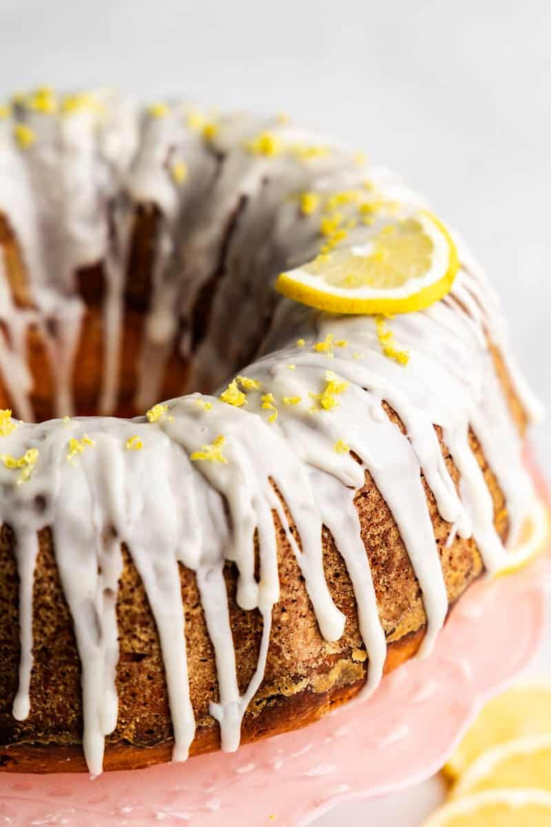 A lemon poundcake bundt loaf on a pink cake platter.