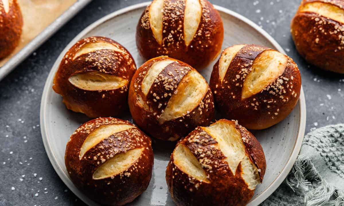 An overhead view of a plate of homemade pretzel rolls.