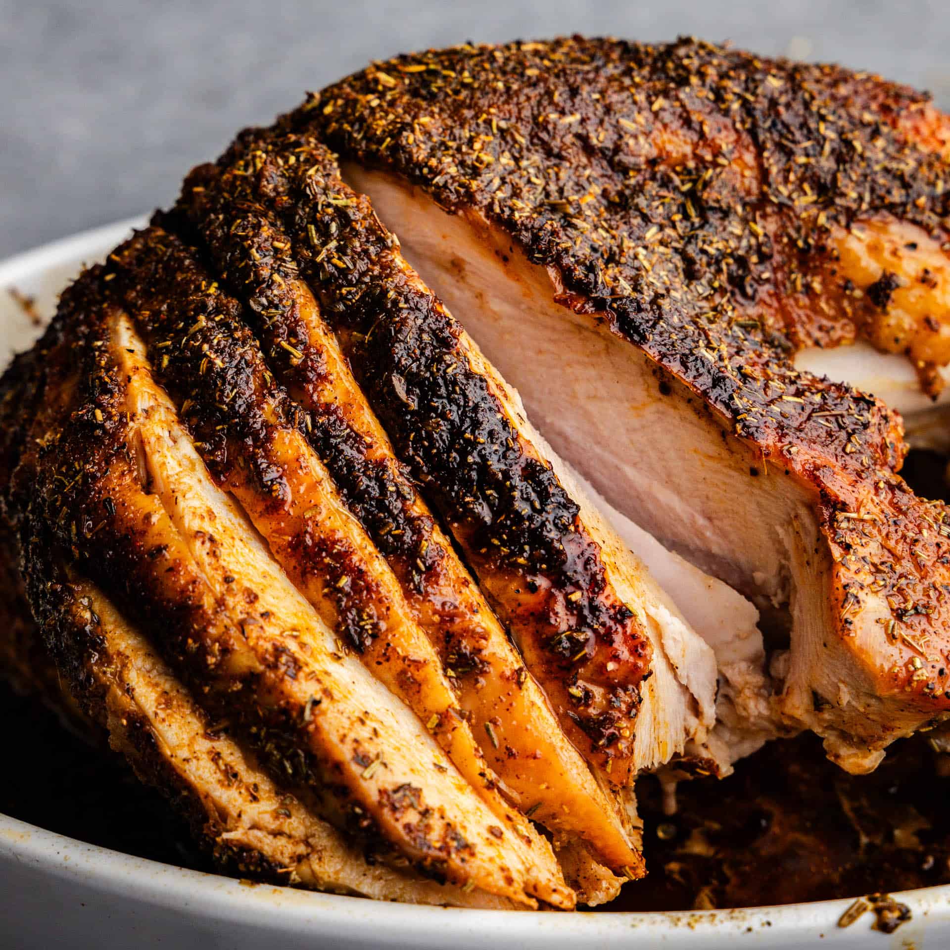 A partially sliced roasted turkey breast.