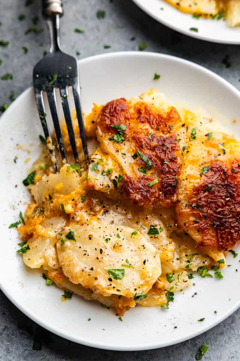 An overhead view of a plate of slow cooker scalloped potatoes.