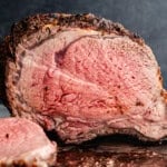 A horseradish crusted prime rib that has been sliced into revealing a medium-rare center.