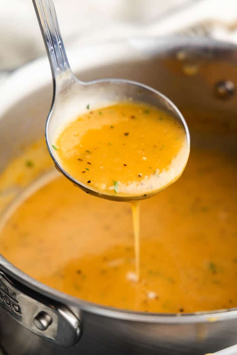 ladle scooping homemade turkey gravy 