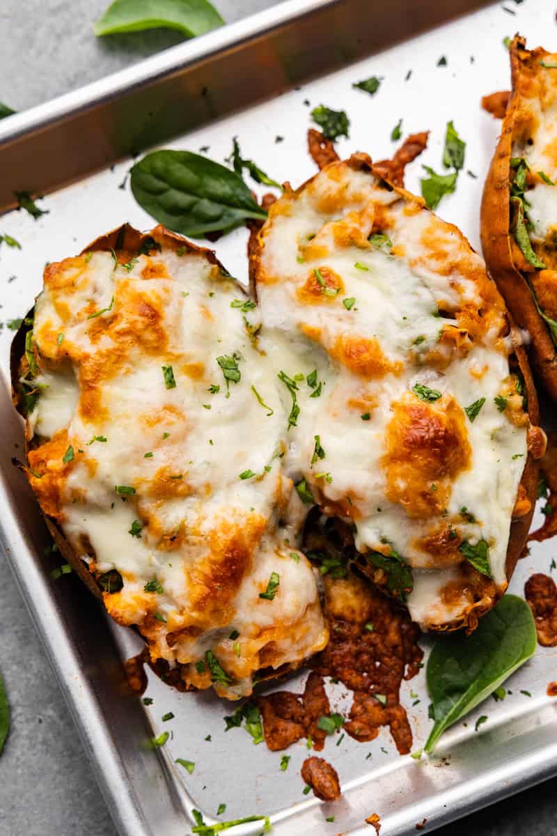 An overhead view of chipotle twice baked sweet potatoes on abaking sheet.