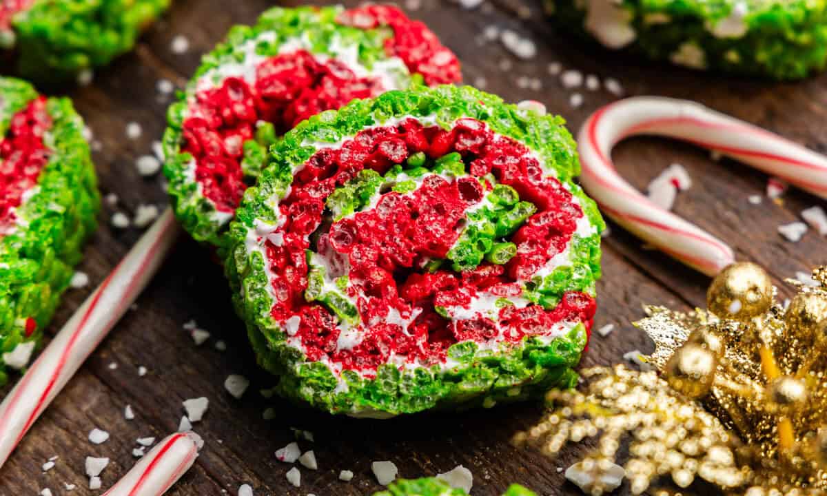 Two slices of Christmas rice krispie treat pinwheels, with layers of red, green, and white.