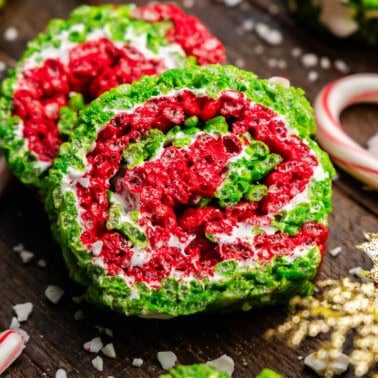 Two slices of Christmas rice krispie treat pinwheels, with layers of red, green, and white.